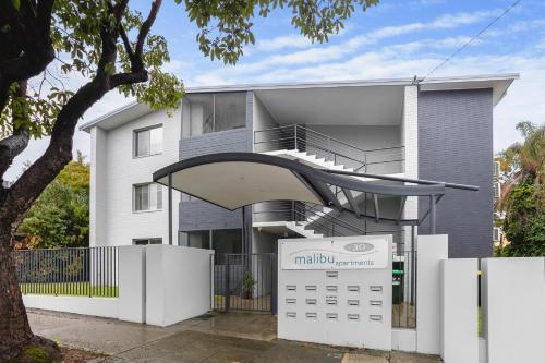 a house with a staircase and a calendar in front of it at Malibu Apartments - Perth in Perth