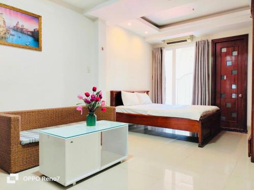 a hotel room with a bed and a couch and a table at Q.MIN apartment in Nha Trang