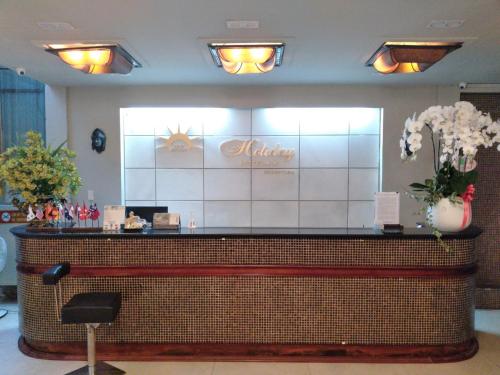 a salon with a counter with flowers on it at Holiday Hotel in Hai Phong