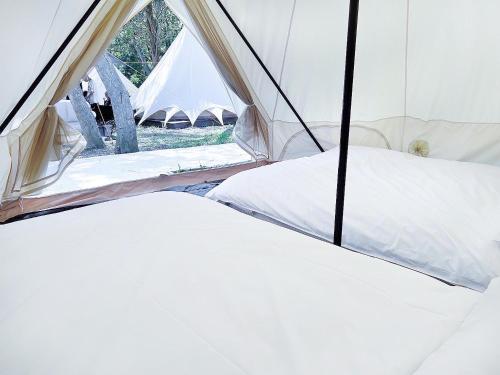 a white tent with a window in it at Touching Camping in Hou-lung-tzu