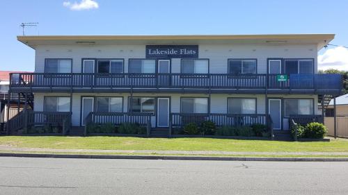 a large building with a sign that reads malibu flats at Lakeside 3 in Tuncurry