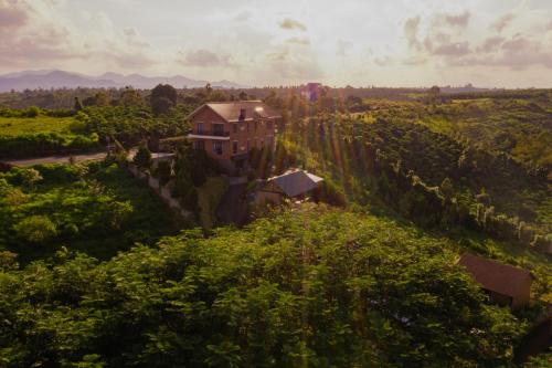 an aerial view of a house on a hill with trees at SEN VILLA Boutique in Bao Loc