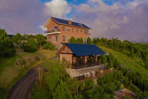 an aerial view of a large house on a hill at SEN VILLA Boutique in Bao Loc