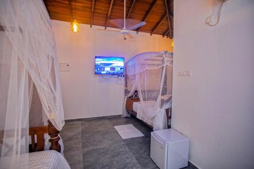 un dormitorio con una cama con mosquitera en Superresidence, en Balapitiya