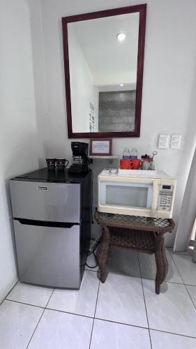 a kitchen with a microwave on a table with a mirror at Rancho Matalote en Valle de Guadalupe in Valle de Guadalupe