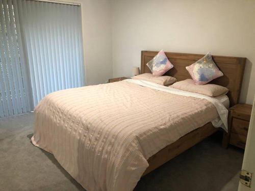 a bedroom with a bed with two pillows on it at Waterfront Luxury 4 bed Home walking to Broadwater in Gold Coast