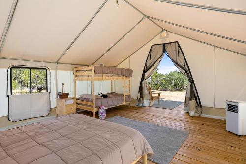 a bedroom with a bed in a tent at Twin Falls Adventure Tent in Boerne