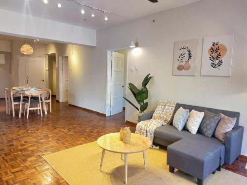 a living room with a couch and a table at Star Regency by Plush in Brinchang