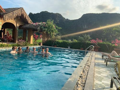 a group of children swimming in a swimming pool at Tam Coc Minh Hung Homestay in Ninh Binh