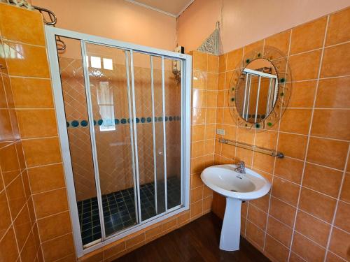 a bathroom with a shower and a sink at Samsen Sam Place in Bangkok