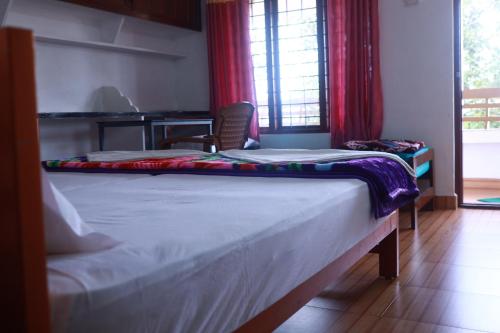 Postel nebo postele na pokoji v ubytování ASHRAMAM HEALTH RESORT