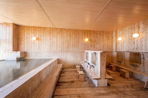 a large room with wooden walls and wooden floors at KIBOTCHA/キボッチャ in Higashimatsushima