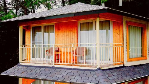 a house with a balcony on top of it at The Woods Retreat in Lansdowne