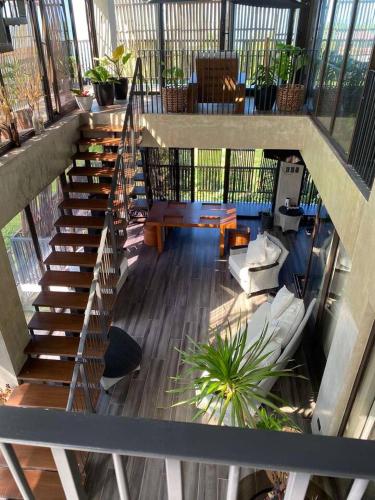 a staircase in a building with a living room at Brisa de Cristal at Canyon Cove Nasugbu Batangas in Nasugbu