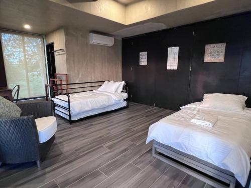 a bedroom with two beds and a table and chairs at Brisa de Cristal at Canyon Cove Nasugbu Batangas in Nasugbu