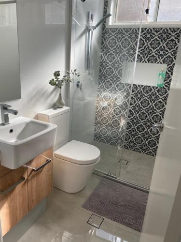 a bathroom with a shower and a toilet and a sink at -The Garden Room - with Private Entrance & Private Bathroom in Wentworthville