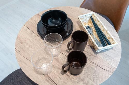 a table with cups and glasses on top of it at uGard Shimomaruko in Tokyo