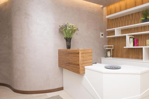 a bathroom with a vase of flowers on the wall at Casa Gaia in Pescara