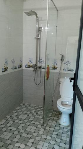 a bathroom with a shower and a toilet at Hotel Thanh Bình 2 in Ha Tinh