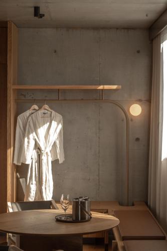 a room with a table and a shirt hanging on a wall at Hotel Marvell Byron Bay in Byron Bay