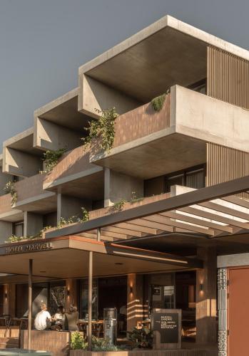 a building with people sitting outside of it at Hotel Marvell Byron Bay in Byron Bay