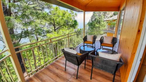 a porch with chairs and tables on a balcony at The Woods Retreat in Lansdowne