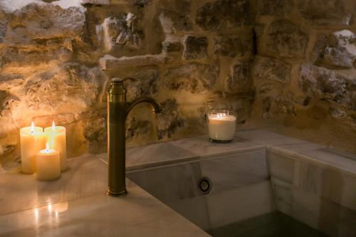 een badkamer met 2 kaarsen en een bad bij AIRE RURAL JIMENA in Jimena de la Frontera