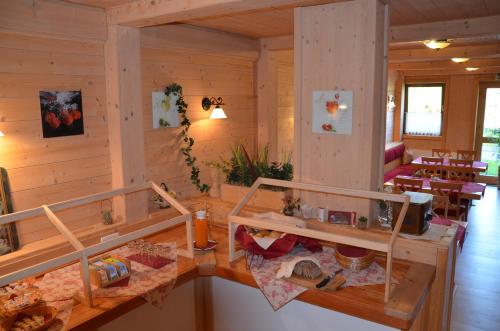 a room with wooden walls and wooden tables and chairs at Pension zum Schreiner in Hermagor