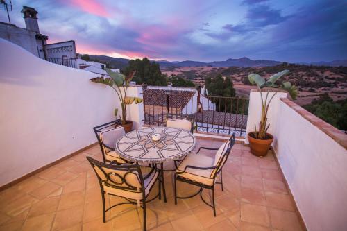 a patio with a table and chairs on a balcony at AIRE RURAL JIMENA in Jimena de la Frontera