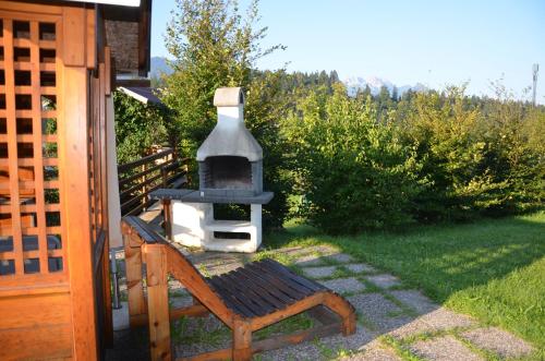 a wood fired oven in a yard next to a house at Pension zum Schreiner in Hermagor