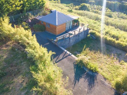 a small wooden cabin in the middle of a field at bambous-bungalows in LʼEntre-Deux