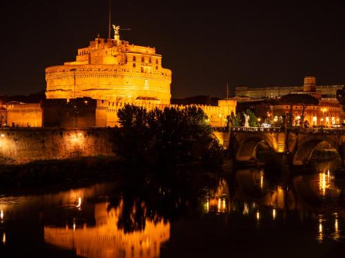 a large building at night with a bridge at Alto Apartment in Rome