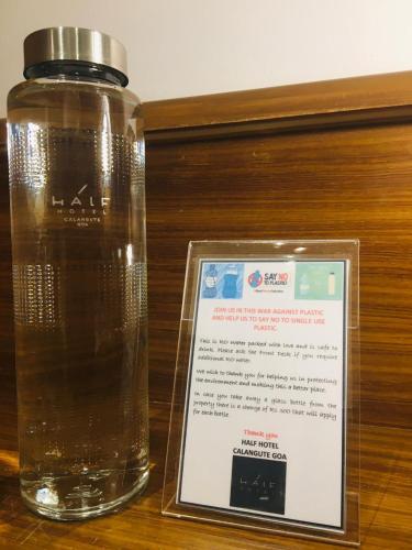 a bottle of water with a sign next to it at HALF Hotel, Calangute in Calangute