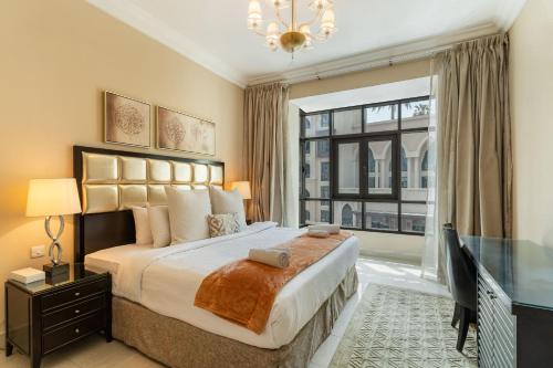 a bedroom with a large bed and a large window at Classic & New - 1BR Apartment in OldTown,Downtown - Allsopp&Allsopp in Dubai