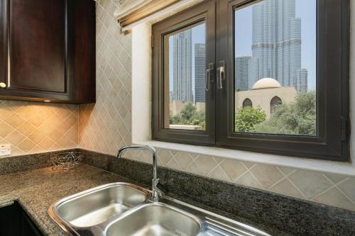 a kitchen with a sink and a window at Classic & New - 1BR Apartment in OldTown,Downtown - Allsopp&Allsopp in Dubai