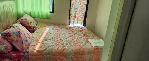 a bedroom with a bed and a window at OSAKA RIVERVIEW in Tangerang