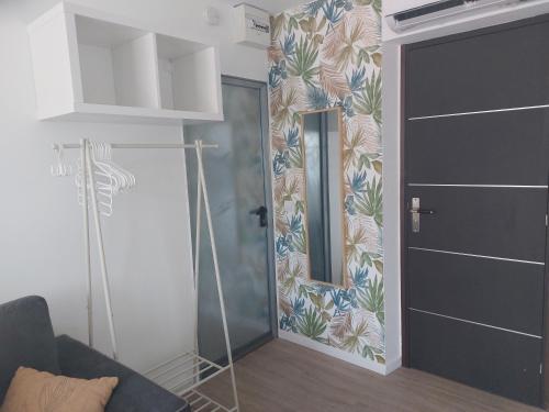 a living room with a door and a mirror at Studio à 2 pas de la plage in Marseille