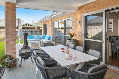 a patio with a white table and chairs at Jakes Place in Dunsborough