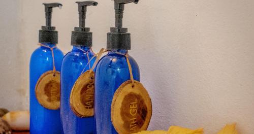 a group of three blue bottles with wooden spoons at Navutu Stars Resort in Matayalevu