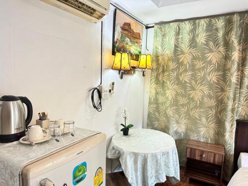 a small kitchen with a table in a room at Soft Resort Kad Farang Hangdong in Ban Yang Plao