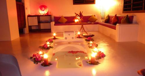 a living room with candles and lights on the floor at Navutu Stars Resort in Matayalevu