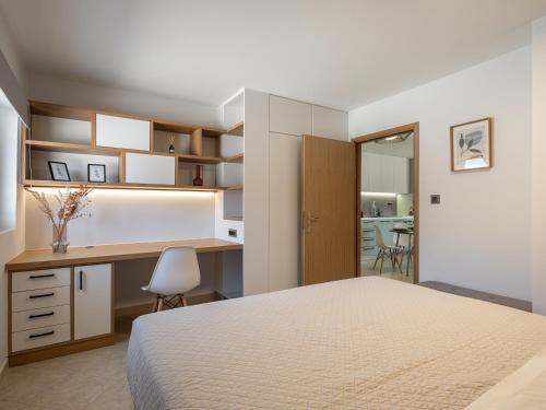 a bedroom with a bed and a desk at Elysian Sea-View Chania in Stérnai