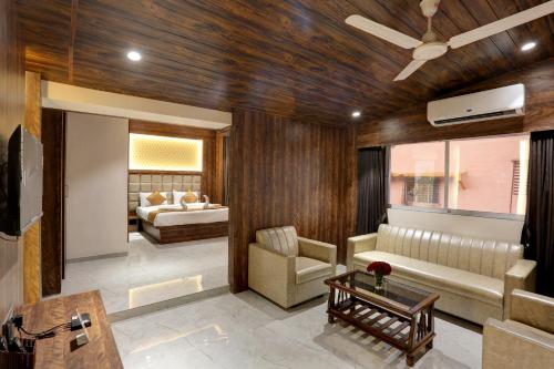 a living room with a couch and a bed at Ramya Residency Navi Mumbai in Navi Mumbai