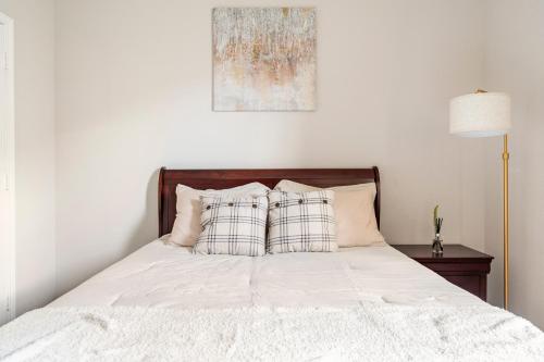 a bed with white sheets and pillows on it at Wonderful Getaway Cypress 2 BR with thoughtful comforts in Cypress
