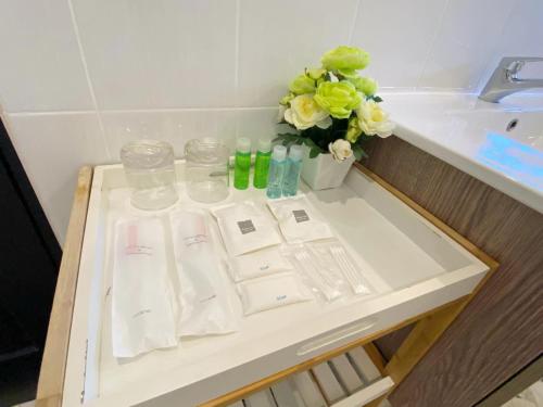 a bathroom counter with white towels and a sink at Sunny Dala villa in Nong Prue