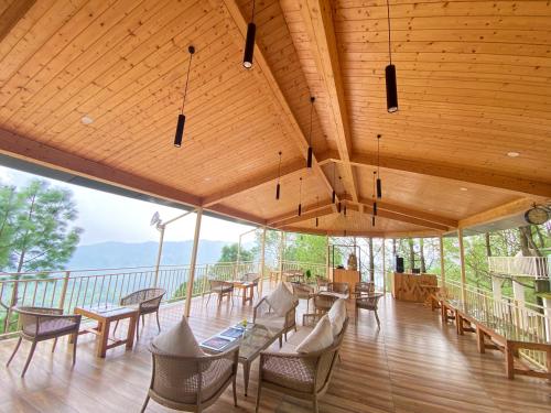 a large room with tables and chairs on a deck at The Woods Retreat in Lansdowne
