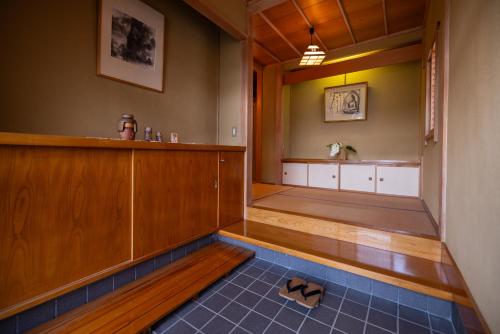 a pair of shoes sitting on the floor of a bathroom at -izen 高田- 柳精庵 in Joetsu
