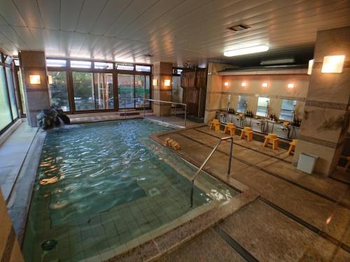 a large indoor swimming pool in a building at Kasuga Hotel in Nara