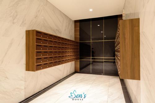 a walk in closet with wood and marble walls at Sens House Saigon - Metropole Luxury Boutique in Ho Chi Minh City