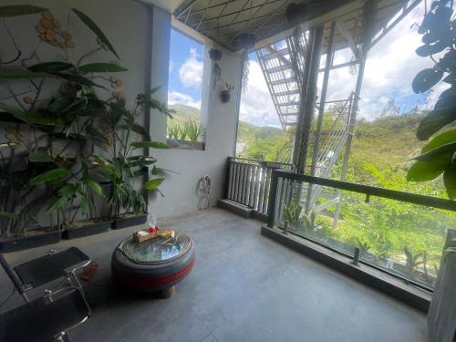 a room with a balcony with a large window at The Grandparents Homestay in Quy Nhon